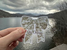 Load image into Gallery viewer, Sticker | ChiO_E | Chi Omega Toile Bow | Waterproof Vinyl Sticker | White | Permanent | Removable | Window Cling | Glitter | Holographic