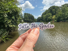 Load image into Gallery viewer, Sticker | DPE_D | Delta Phi Epsilon Signature | Waterproof Vinyl Sticker | White | Clear | Permanent | Removable | Window Cling | Glitter | Holographic