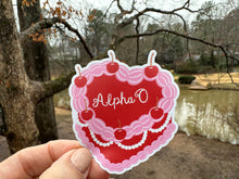 Load image into Gallery viewer, Sticker | AOP_C | Alpha Omicron Pi Heart Shaped Cake | Waterproof Vinyl Sticker | White | Clear | Permanent | Removable | Window Cling | Glitter | Holographic