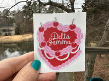 Load image into Gallery viewer, Sticker | DG_C | Delta Gamma Heart Shaped Cake | Waterproof Vinyl Sticker | White | Clear | Permanent | Removable | Window Cling | Glitter | Holographic