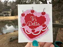 Load image into Gallery viewer, Sticker | DDD_C | Tri Delta Heart Shaped Cake | Waterproof Vinyl Sticker | White | Clear | Permanent | Removable | Window Cling | Glitter | Holographic