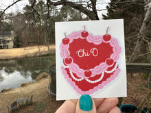 Load image into Gallery viewer, Sticker | ChiO_C | Chi Omega Heart Shaped Cake | Waterproof Vinyl Sticker | White | Clear | Permanent | Removable | Window Cling | Glitter | Holographic