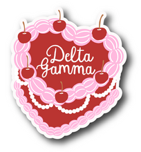 Load image into Gallery viewer, Sticker | DG_C | Delta Gamma Heart Shaped Cake | Waterproof Vinyl Sticker | White | Clear | Permanent | Removable | Window Cling | Glitter | Holographic